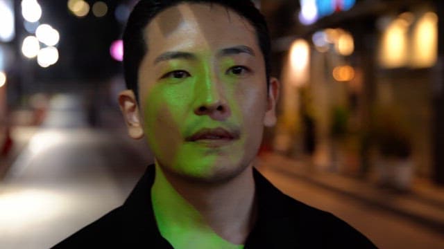 Man walking on a city street at night