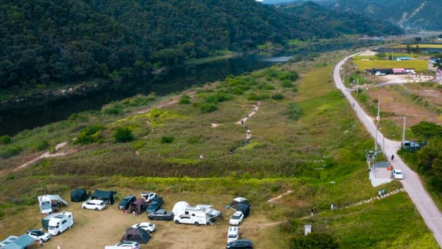 People at the Riverside Campsite to Enjoy Camping 