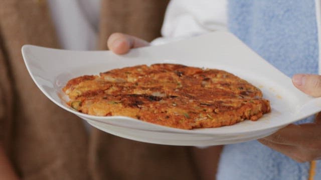 Appetizing kimchi pancake served on a white plate