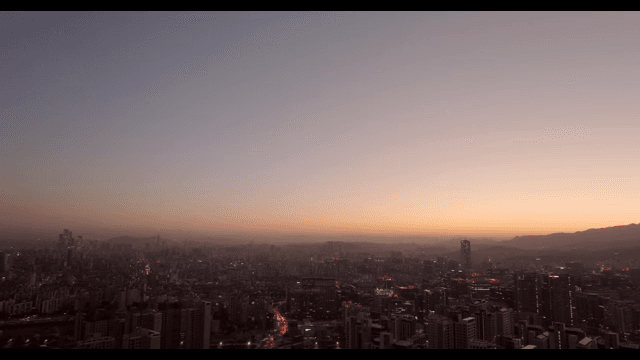 City skyline at dusk with glowing lights