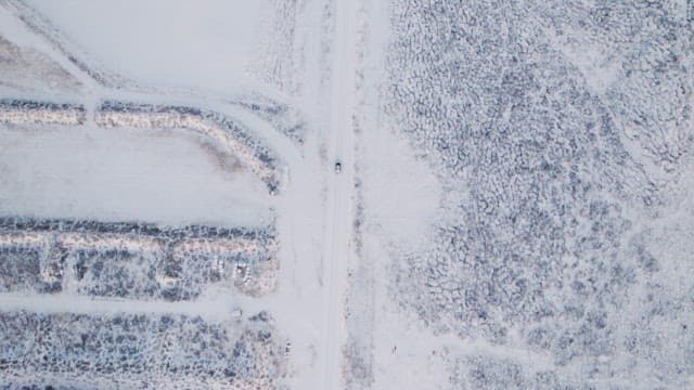 Car driving through a snowy landscape