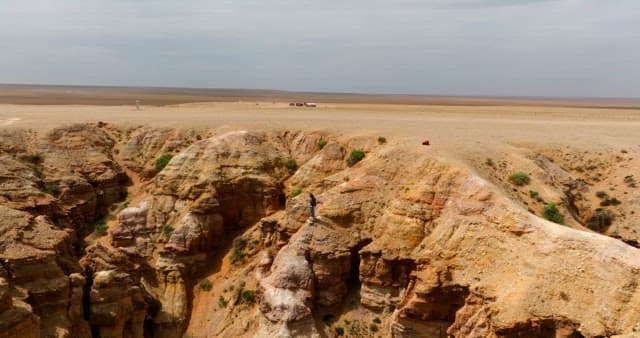 Person standing on a rocky desert cliff