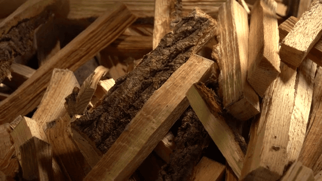 Stack of chopped firewood with bark