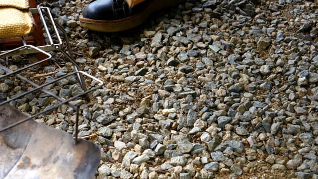Preparing firewood with gloved hands in outdoor setting