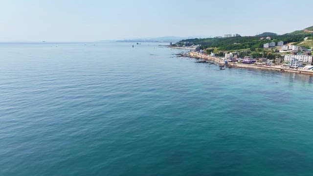 Coastal town with a lighthouse and clear sea