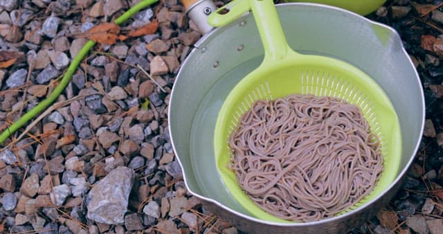 Cooking noodles in an outdoor setting