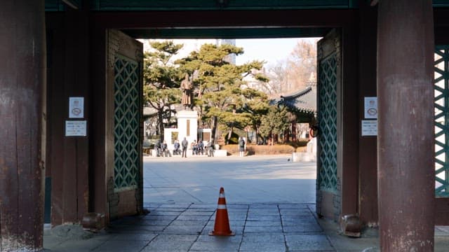 Traditional Korean gate with a statue