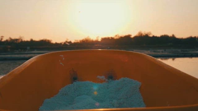 Sunset View over a Wheelbarrow Filled with Salt