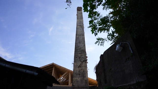 Tall and old chimney under a clear sky