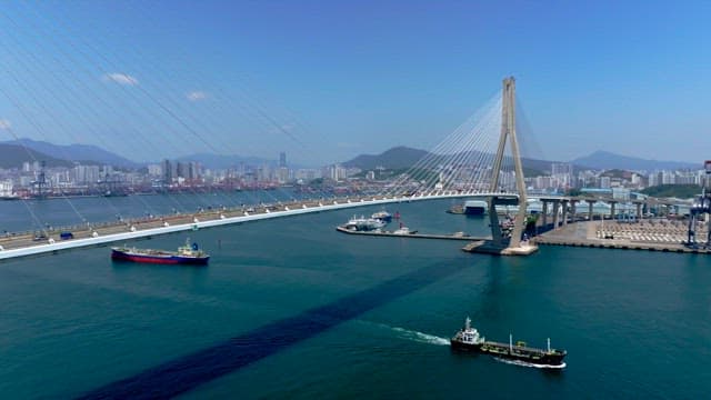 Gwangandaegyo Bridge with ships passing underneath on a clear day