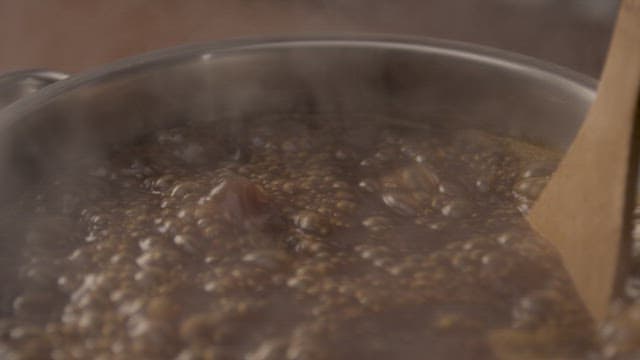 Stirring Boiling Beans in a Pot
