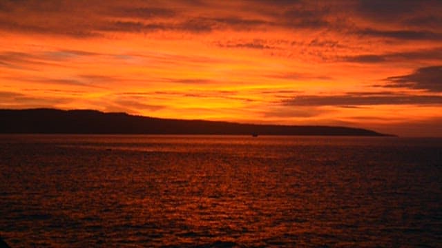 Fiery Sunset Over a Tranquil Sea