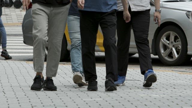 Pedestrians Crossing Busy City Street