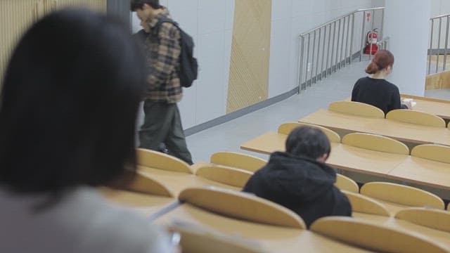 Students gathering in a college lecture hall