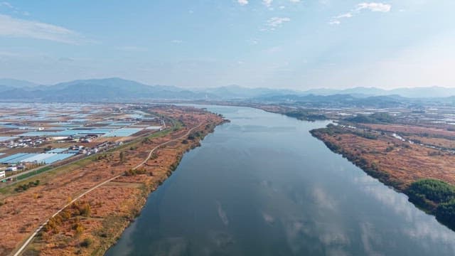 Serene river flowing through farmland