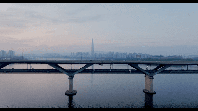 Bridge over a river with city skyline