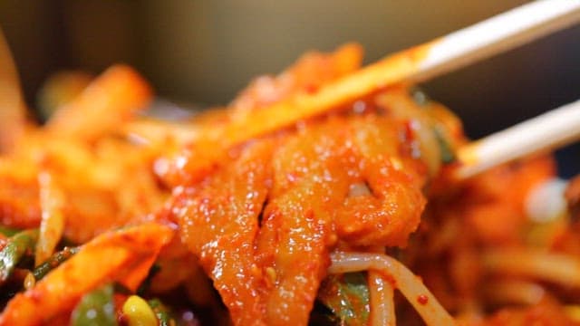 Chopsticks holding appetizing cow skin salad