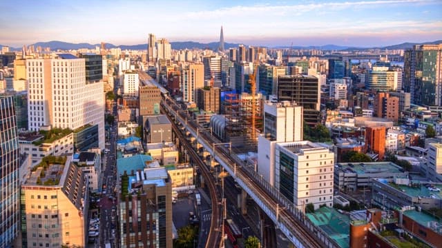 Elevated view of a bustling city with a railway