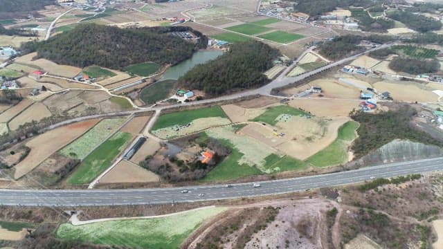 Expansive farmland with roads and hills