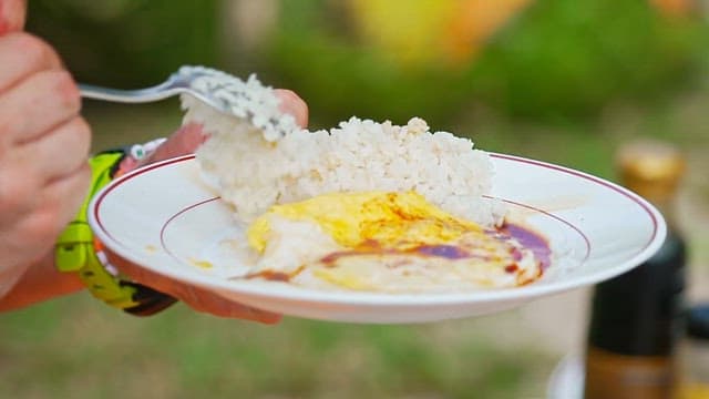 Egg rice with soy sauce mixed with a spoon