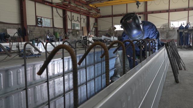 Worker welding inside a metal structure