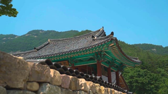 Traditional Korean architecture with mountain backdrop