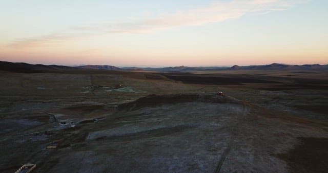 Landscape of barren fields with distant hills