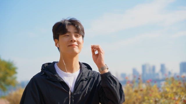 Young man enjoying music outdoors