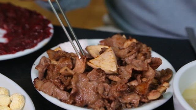 Grilled beef tendon and mushrooms on a plate
