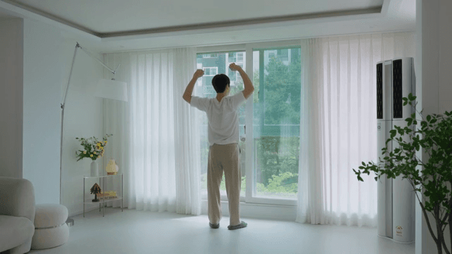 Man opening curtains in modern living room in white interior