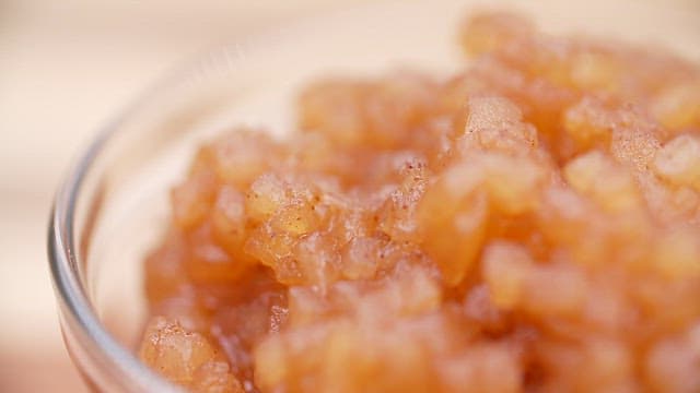 Thick apple jam in a clear glass bowl