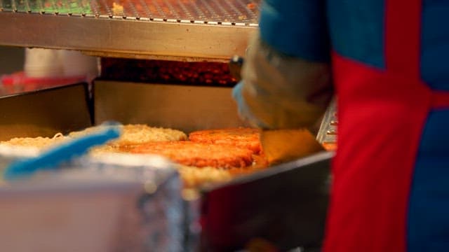 Street vendor at Gwangjang Market grilling pancakes
