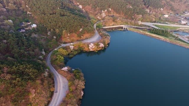Winding road by a serene lake