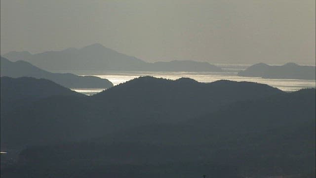 Serene Mountain Landscape with Glistening Water