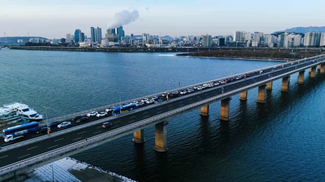 Busy Bridge over River in the Evening