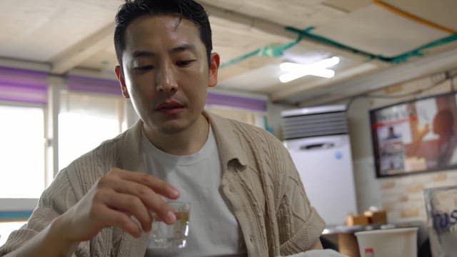 Man drinking alcohol with a worried face