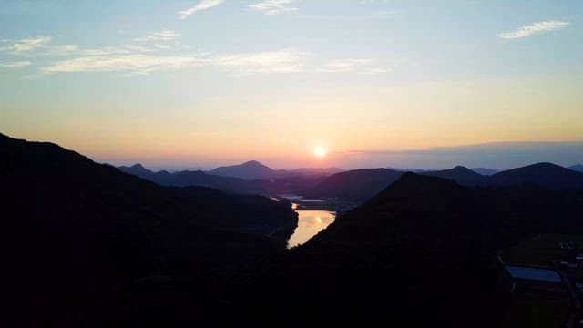 Serene Sunrise Over a Tranquil Mountain Landscape