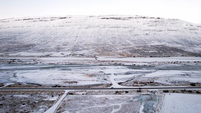 Snowy mountains and road with cars