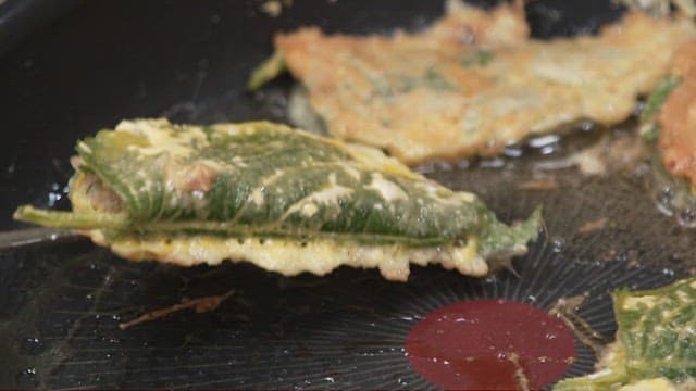 Perilla leaf pancakes fried to golden brown in a hot oiled pan