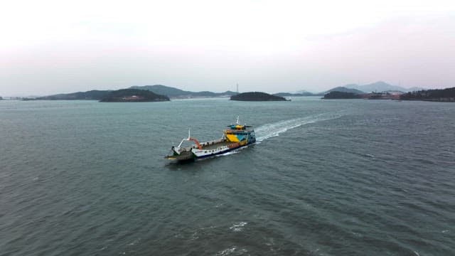 Boat Traversing Serene Coastal Waters