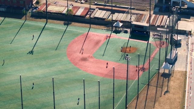 Baseball field with players practicing