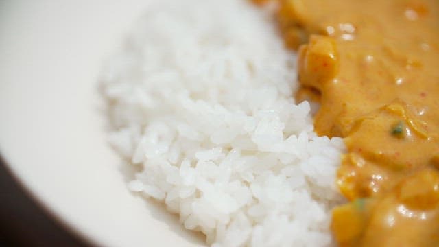 Rice served with creamy milk curry sauce