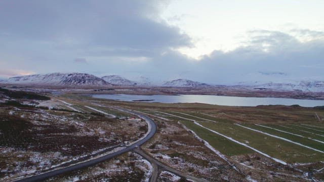 Snow-covered mountains and a winding road