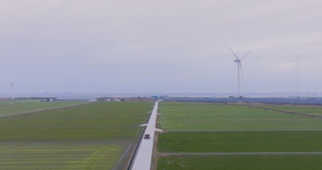 Car driving through vast green fields