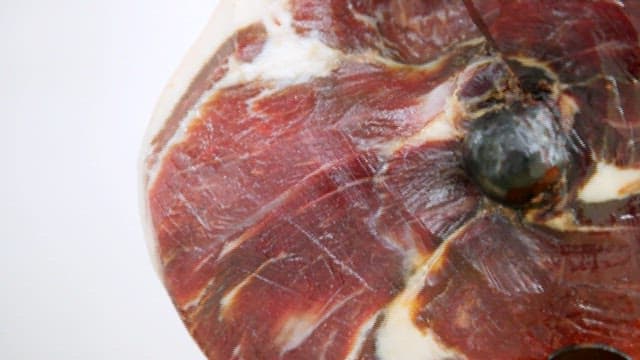 Slicing quality cured meat on a board