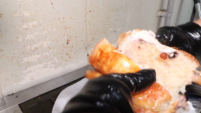 Preparing a golden Rotisserie Chicken in the restaurant kitchen