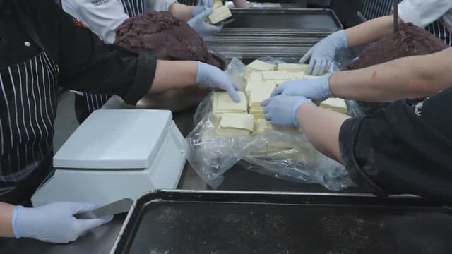 Workers preparing butter and red bean paste in the kitchen