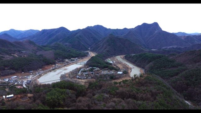 Village surrounded by rivers and lush green mountains