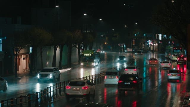 Nighttime city street scene with cars