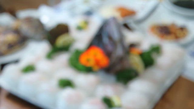 Plate of fresh raw fish with fish head on top